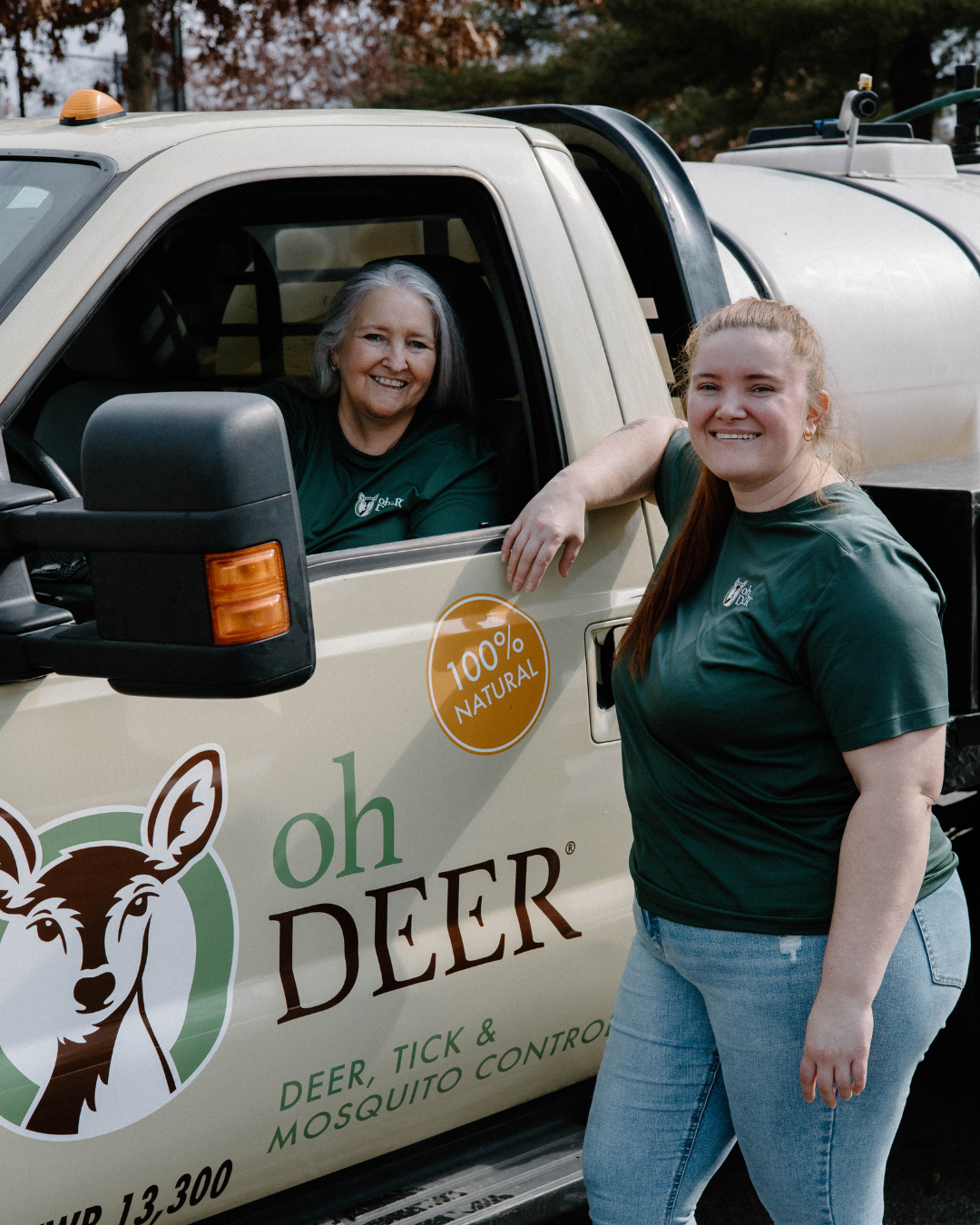 Smiling women in green shirts pose with their