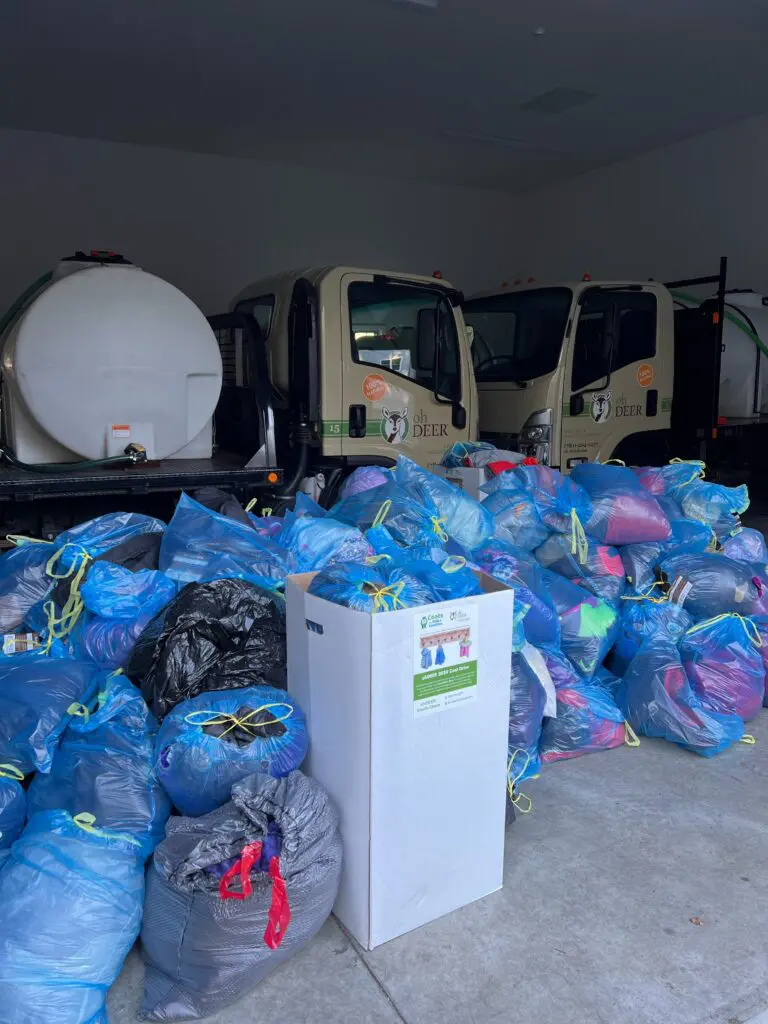 ohDEER trucks and piles of donated coats for coat drive 