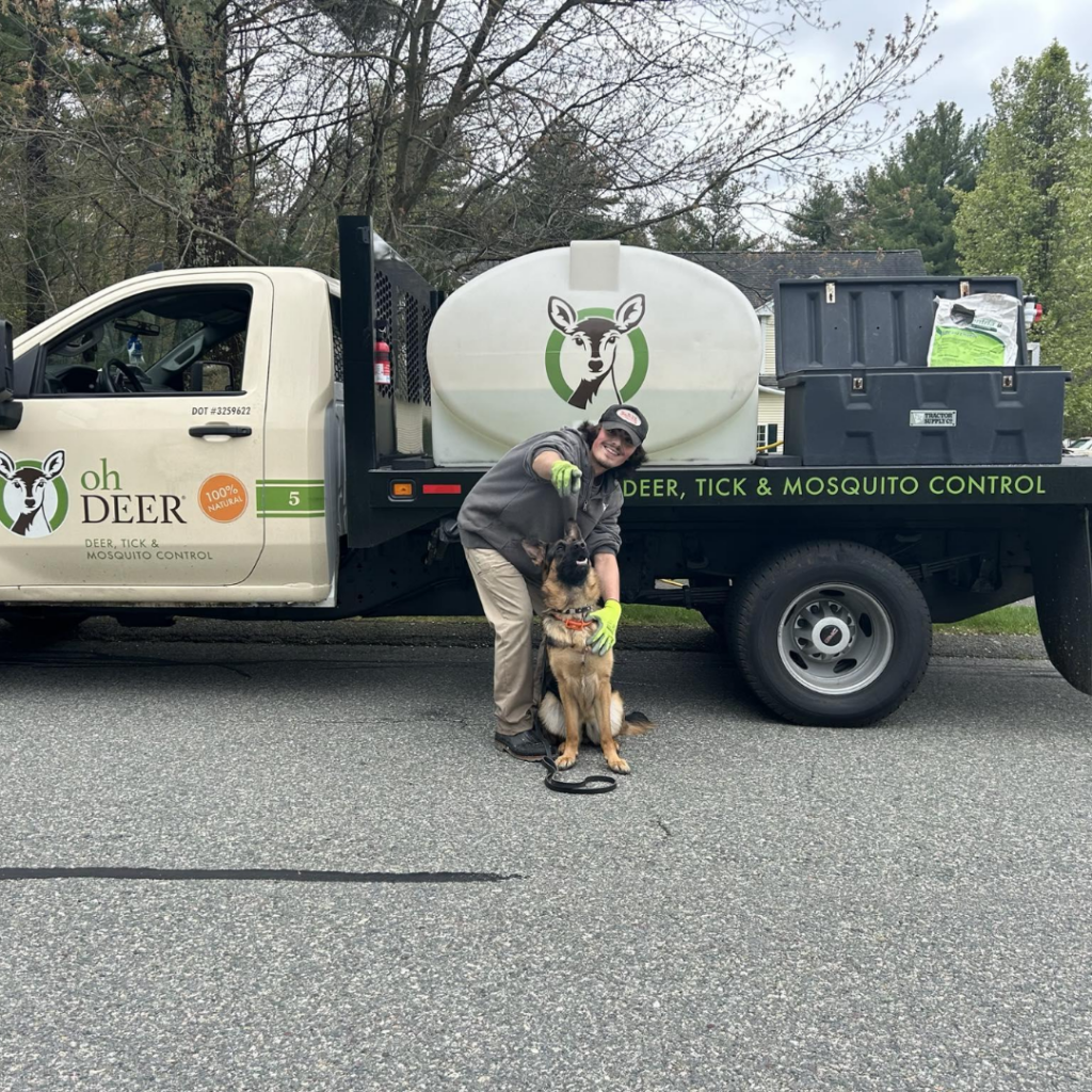 ohDEER technician with German Shepard dog in front of truck 