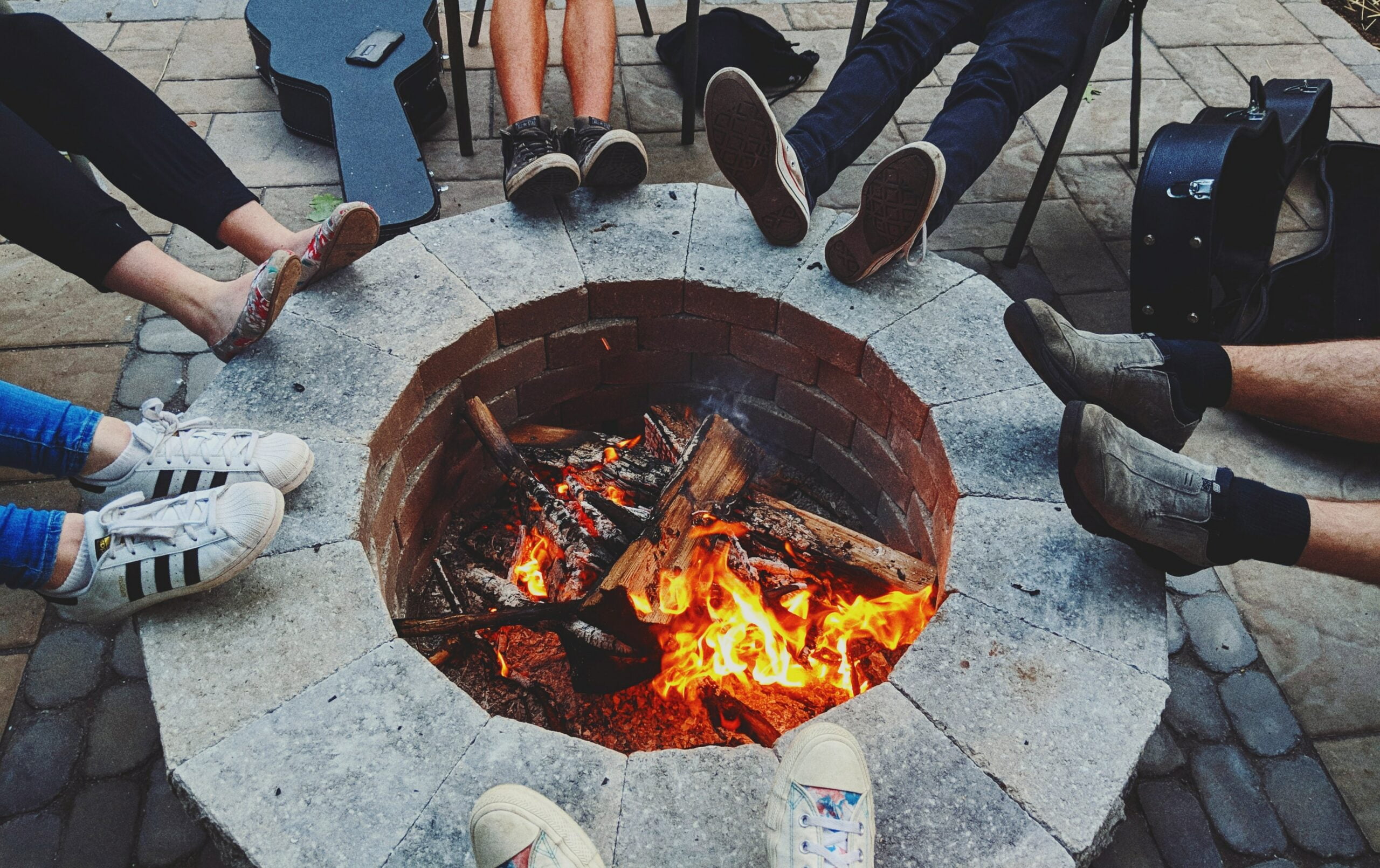 People enjoying a fire pit thanks to All-Natural Tick & Mosquito Control