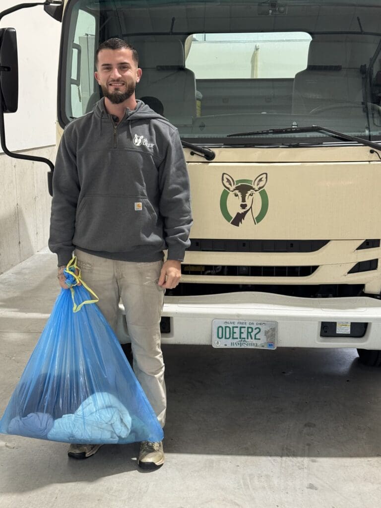ohDEER North Shore technician with coats collected from 2025 ohDEER Annual Coat Drive