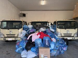 ohDEER community support coat drive coats piled in front of trucks