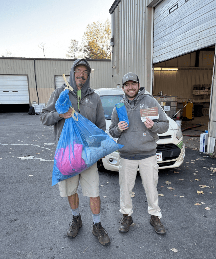 ohDEER Metro West technicians holding coats collected from customers for ohDEER coat drive
