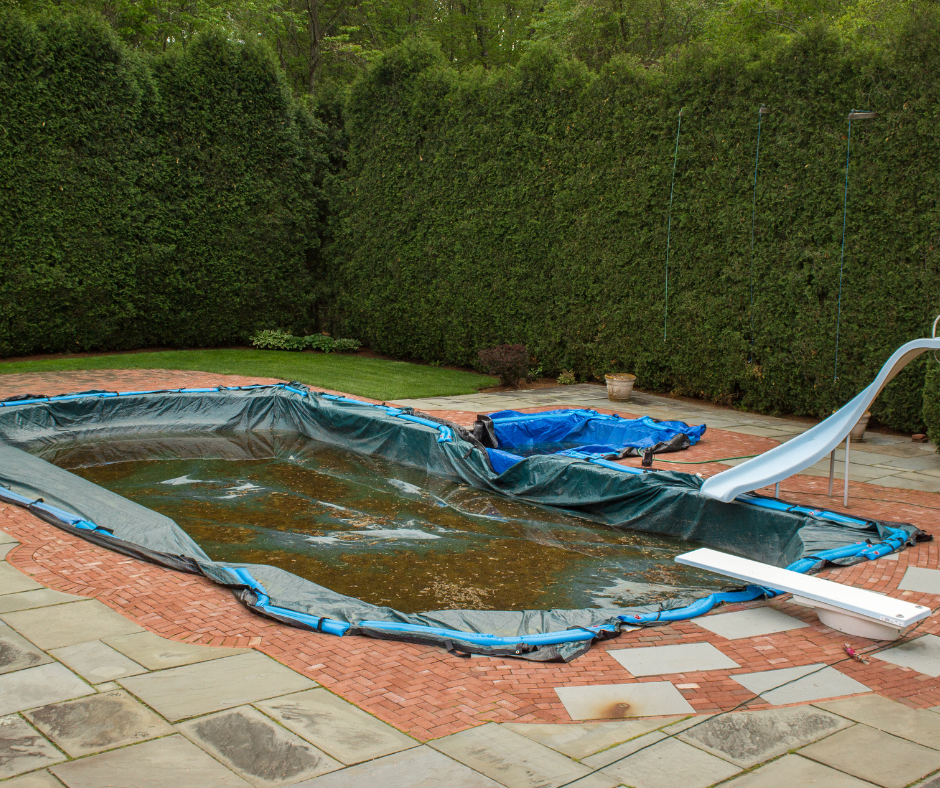standing water collecting on inground pool cover in back yard 